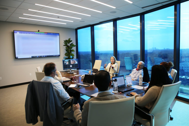 committee members sitting around the table in the board room