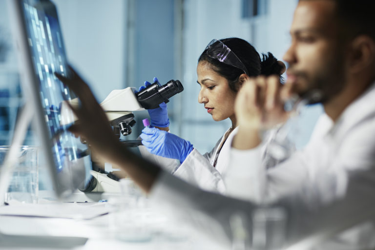 Scientist Working on Computer In Modern Laboratory
NOTE TO INSPECTOR: all graps, dna models, charts are made by me