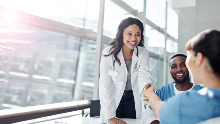 Shot of medical practitioners shaking hands in a meeting