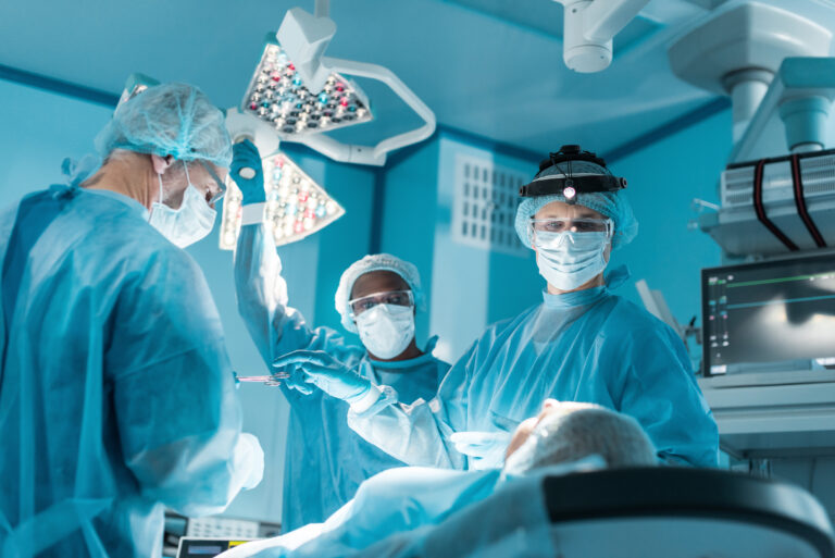 multicultural surgeons and patient during surgery in operating room